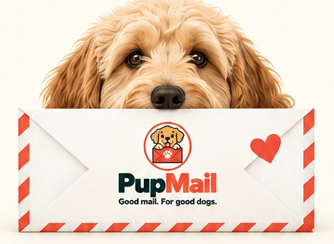 A happy dog peeking over a PupMail envelope
